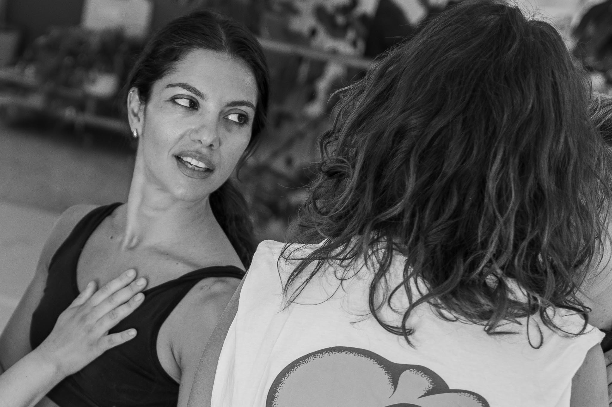 Vilelmini during the workshop, hand placed on her chest in a gesture of connection.